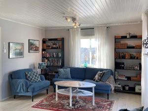 a living room with a blue couch and a table at Holiday home MARSTRAND III in Marstrand