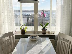a dining room with a table and two chairs and a window at Holiday home MARSTRAND III in Marstrand