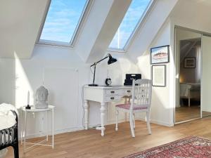 a white desk with a lamp and a chair in a room at Holiday home MARSTRAND III in Marstrand