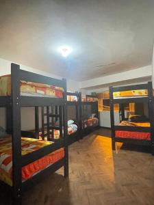 a group of bunk beds in a room at Mundo Viajero Saphy in Cusco