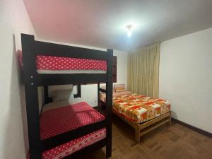 a bedroom with two bunk beds and a bed at Mundo Viajero Saphy in Cusco