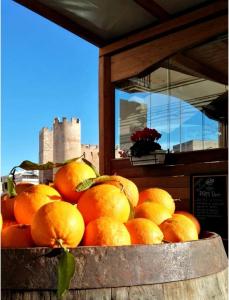 a bunch of oranges sitting in a wooden bowl at Agli Antichi Quartieri Apartments in Alcamo