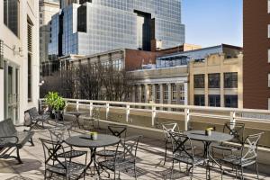 a patio with tables and chairs on a balcony with buildings at Crowne Plaza Cleveland at Playhouse Square, an IHG Hotel in Cleveland