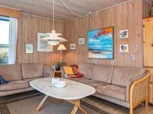 a living room with a couch and a table at 6 person holiday home in Glesborg in Glesborg