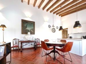 a kitchen and dining room with a table and chairs at A Capela - A Essência de Sintra in Sintra