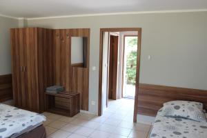 a bedroom with two beds and a door to a doorway at Oaza in Turawa