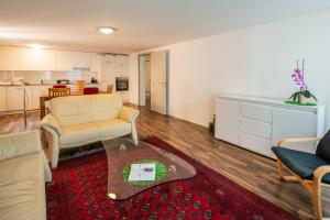 a living room with a couch and a table at Schützenmatt Ferienwohnung in Altdorf