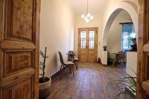 a hallway with a table and chairs in a room at Branko's Residence in Timişoara