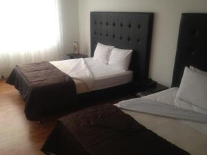 Postel nebo postele na pokoji v ubytování Hotel Dorado Plaza Bogota