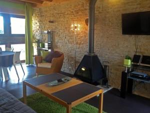 a living room with a wood stove in a room at Gîtes L'Art d'une Pause in Champagny-sous-Uxelles