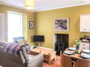 a living room with a couch and a table at City Cottage in Liberton