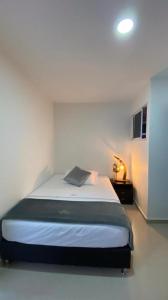 een slaapkamer met een bed in een witte kamer bij Hotel Dorado San Luis in San Luis