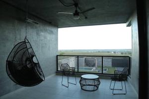 a room with chairs and a table and a large window at Casa en Allende con alberca (Casa Guaname) 