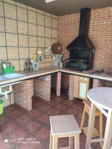 a kitchen with a stove and a table in it at Casa Rosas in Vélez-Málaga