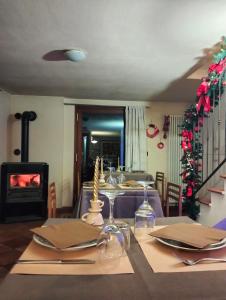 a dining room with a table and a fireplace at Affittacamere I Picchi in Gressan