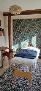 a bedroom with a bed and a wall at Chambre d hôte Beaumont pied de bœuf in Beaumont-Pied-de-Boeuf