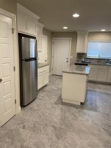 a kitchen with a refrigerator and a counter top at Beautiful Home Fully Equipped, Sleeps 8! in Springdale