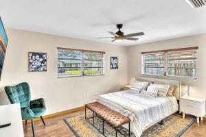 a bedroom with a bed and a ceiling fan at Pool Heat I Firepit and BBQ I 75"TV I Foosball I 581mbps in Cooper City +24 photos