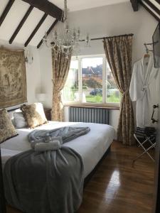 a bedroom with a large bed and a window at Achill Guest House in Solihull +1 photo