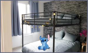 a room with a bunk bed with a mickey mouse on it at Salle de jeux enfant 10min de disney transport en commun 1 chambre 4 couchages et 2 dans le salon in Chanteloup-en-Brie