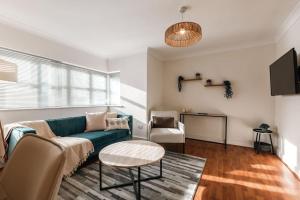a living room with a couch and a table at Azurite - 2 bedroom Flat in Southampton