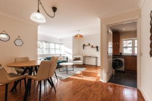 a living room and dining room with a table and chairs at Azurite - 2 bedroom Flat in Southampton