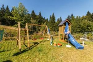 a playground with a slide and a swing set at Apartment, 2 bedrooms, kitchen+2 bathrooms in Mitterfirmiansreut