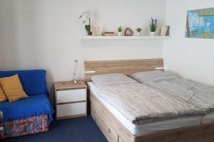 a bed and a chair in a room at Family Apartment, 2 Bedrooms, 2 Bathrooms, Bavarian Forest in Mitterfirmiansreut