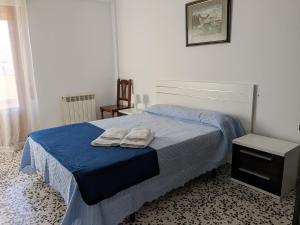 a bedroom with a bed with two towels on it at La Cruz Negra de Veruela in Vera de Moncayo