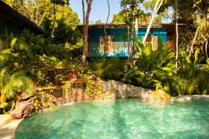 a swimming pool in front of a house at Vila Marina in Arraial d'Ajuda