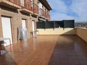 a balcony with chairs and a table on a building at La Cruz Negra de Veruela in Vera de Moncayo