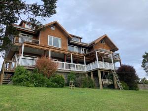 a large wooden house on a hill with at Hostal Casa Grande in Puerto Montt