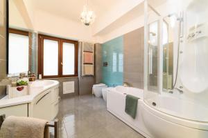 a bathroom with a tub and a toilet and a sink at HomeAway Salerno in Salerno