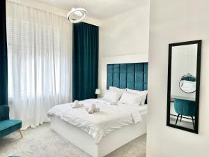 a bedroom with a large bed and a mirror at Bed & Breakfast Donji Grad in Zagreb