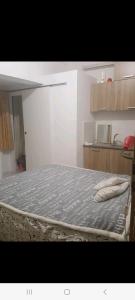 a bedroom with a bed with a blue comforter at City Large Studio in Limassol