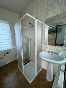 a bathroom with a shower and a sink at Appartamenti Le Calle in Nago-Torbole