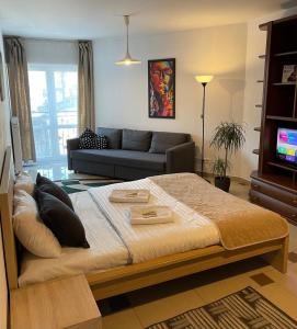 a living room with a bed and a couch at Bubble Apartments in Krakow
