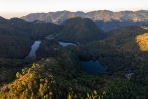 an aerial view of two lakes in the mountains at The Canadian Woods Resort in Nainital