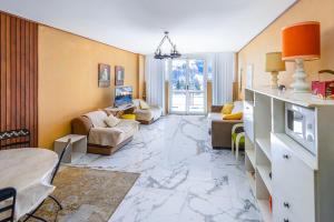 a large living room with a marble floor at Zona Portici in Prato Nevoso +83 photos