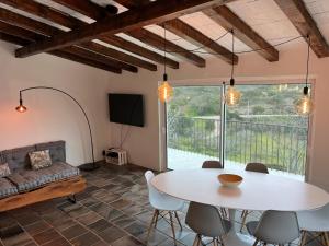 a living room with a table and chairs and a couch at Nature&Soul - Sol in Vila do Bispo