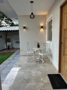 a patio with a table and chairs on a patio at Casas do Serrano - Lençóis in Lençóis +4 photos