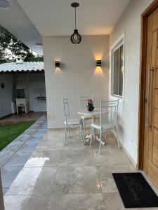 a patio with a table and chairs on a patio at Casas do Serrano in Lençóis