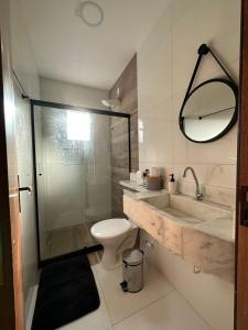 a bathroom with a toilet and a sink and a shower at Casas do Serrano in Lençóis