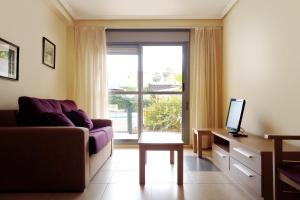 a living room with a couch and a window at Complejo Turístico Marina Rey in Vera