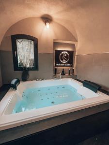 a jacuzzi tub in a room with a ceiling at Talking Stones in Dolceacqua