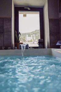 a bath tub with a water fountain in a room at Talking Stones in Dolceacqua