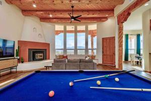 a living room with a pool table and a couch at New Mexico Style Home, Stunning Views & Sunrise in Rio Rancho