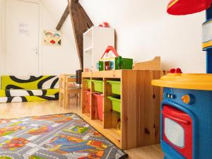 Habitación infantil con zona de juegos con estante para libros en Gîte ti Goudoul bébés enfants friendly en Moëlan-sur-Mer