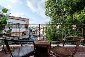 a balcony with a table and chairs on a balcony at Vintage high design lofts -by Bookiz in Tel Aviv