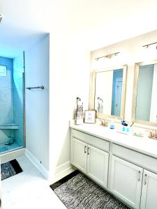 a bathroom with a sink and a shower at Pink Sand Hideaway in Hilton Head Island